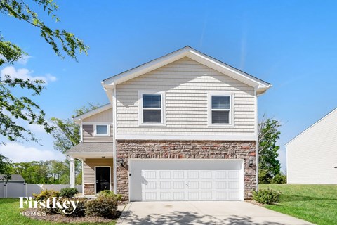 A two-story house with a garage is for sale.