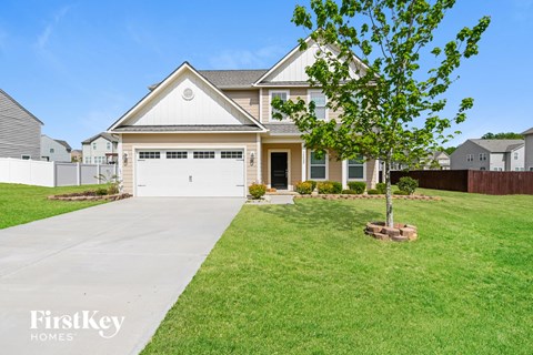 A large house with a tree in front of it.