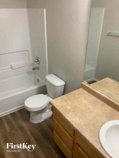 a bathroom with a toilet and a tub and a sink