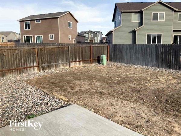 a backyard with a fence and some houses