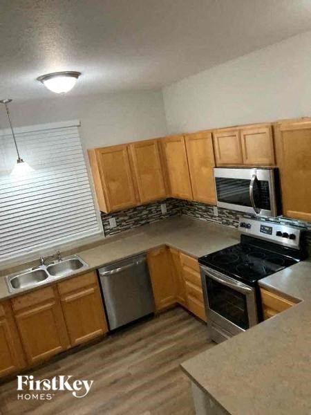 a kitchen with wooden cabinets and stainless steel appliances