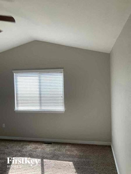 an empty room with a window and a carpet