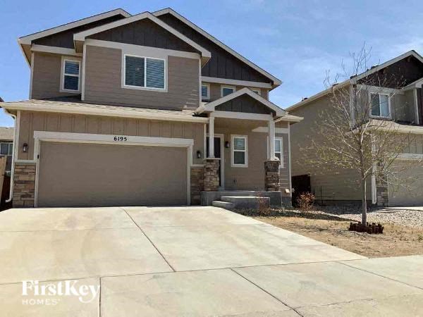 a house with a driveway and a garage door