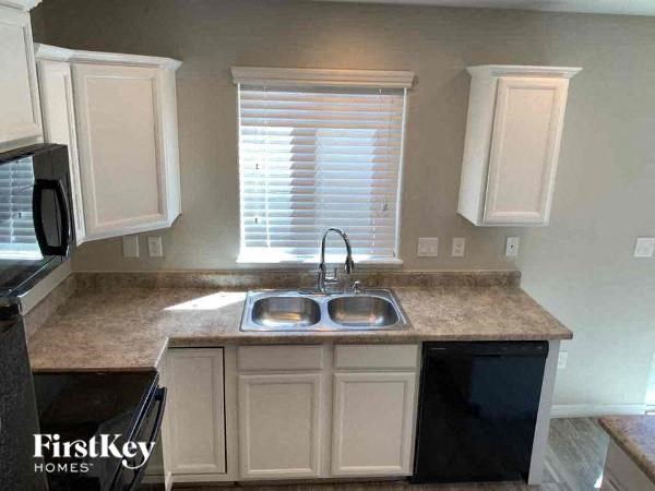 a kitchen with white cabinets and a sink