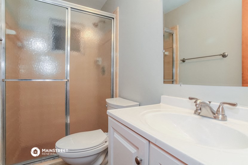 a bathroom with a sink toilet and a shower