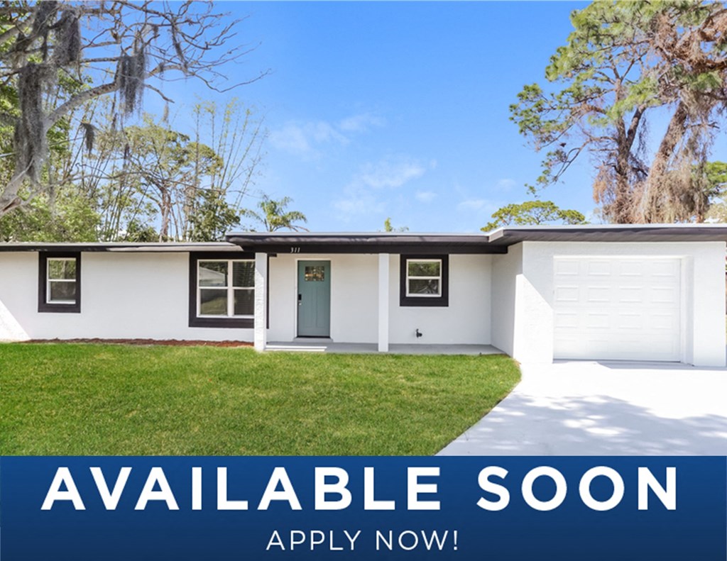 a white house with a lawn and aarpable soon apply now