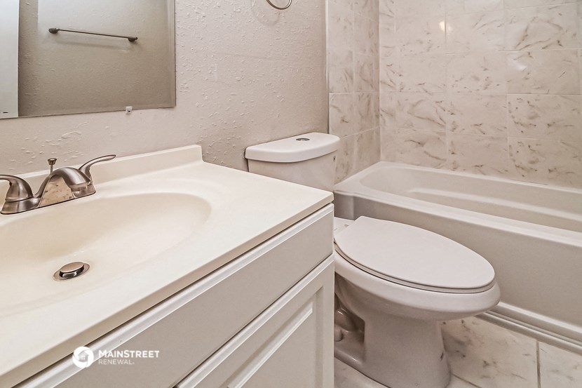 a bathroom with a sink toilet and a bath tub