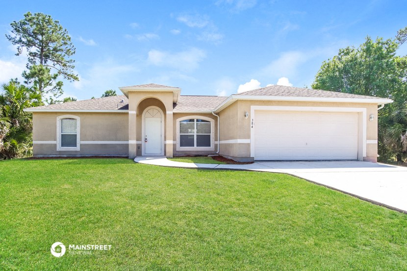 a beige house with a lawn and a garage door