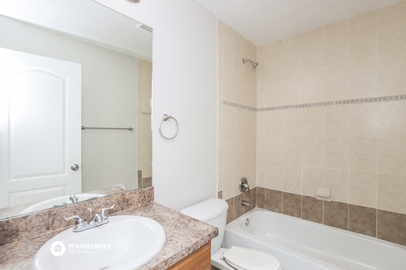 a bathroom with a tub and a sink and a toilet