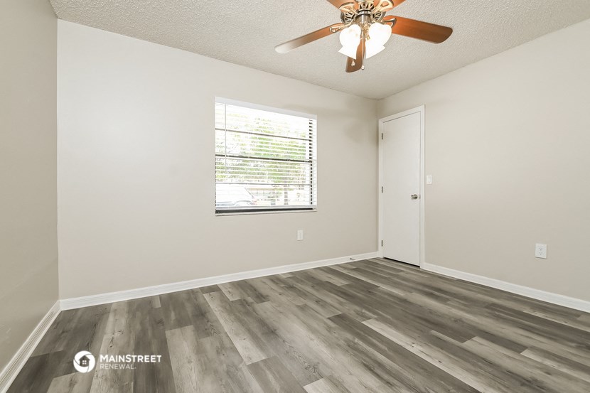 the living room of our studio apartment atrium with a ceiling fan