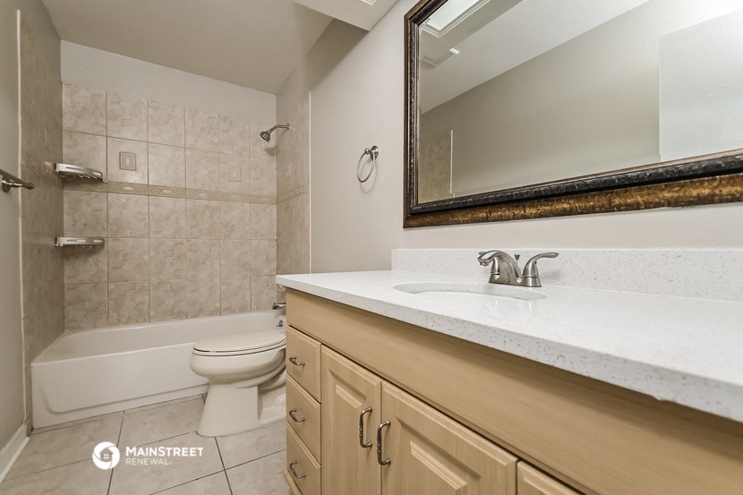 a bathroom with a sink and a toilet and a shower