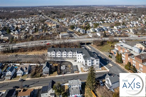 an aerial view of a neighborhood with houses and a highway