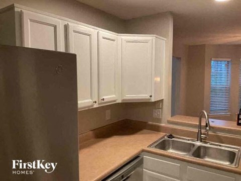 A kitchen with a sink and cabinets.