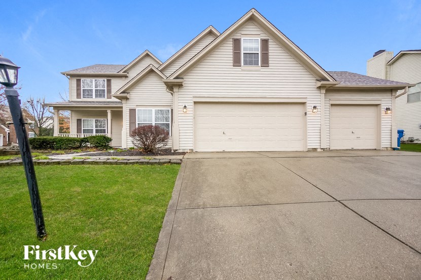 a white house with a driveway in front of it