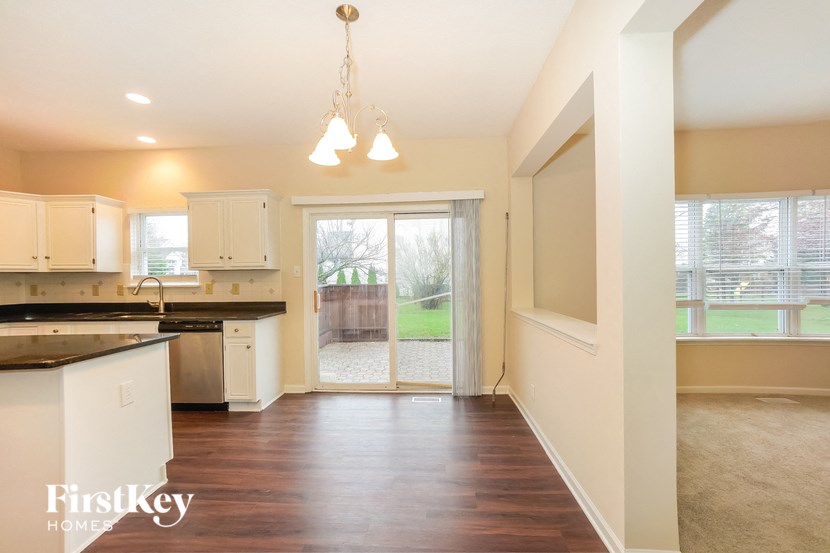 an empty kitchen with a sliding glass door to a patio
