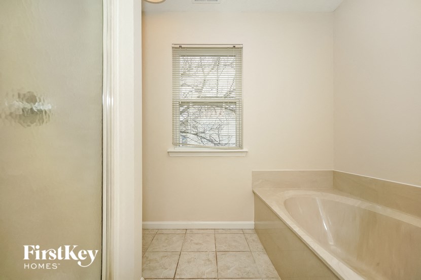 a bathroom with a bath tub and a window