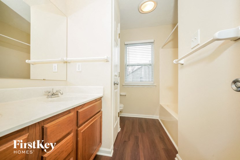 a bathroom with a shower and a sink and a mirror