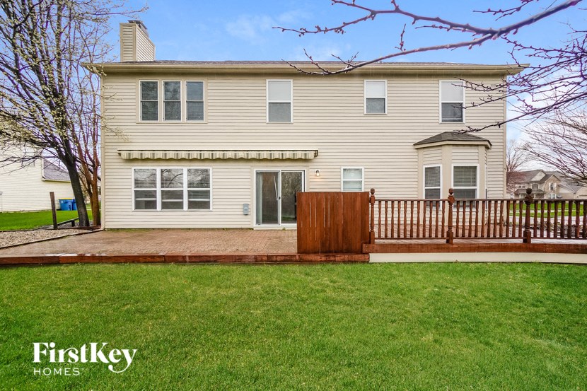 a white house with a wooden fence in front of it