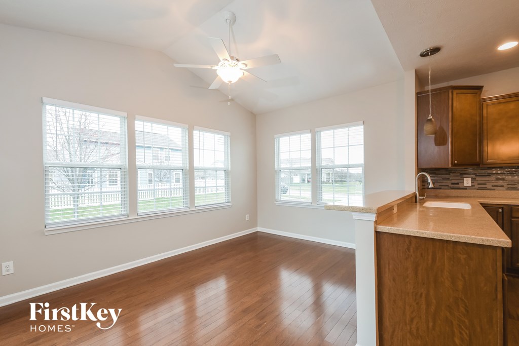 A kitchen with wooden cabinets and a marble countertop.