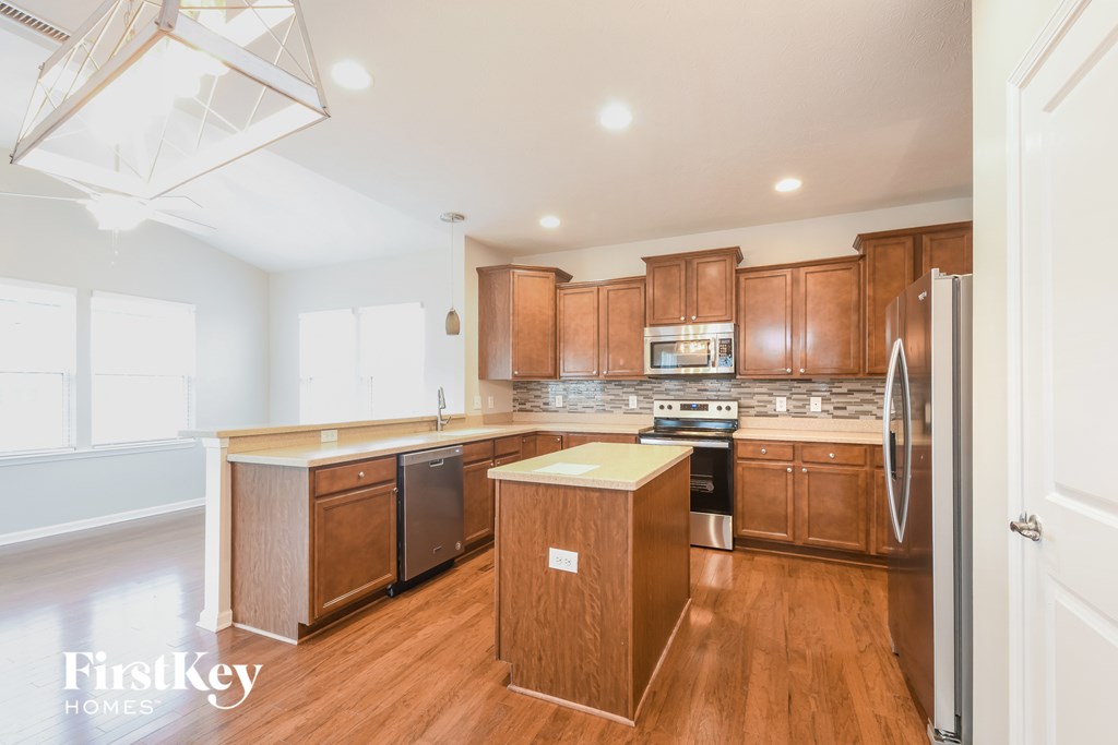 A kitchen with wooden cabinets and a white fridge.