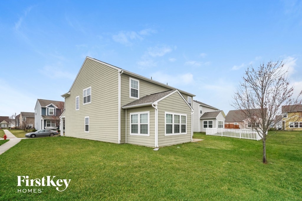 A house with a tree in front of it.