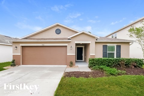A house with a brown garage door and a grey door.