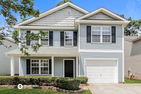 a blue house with a white garage door