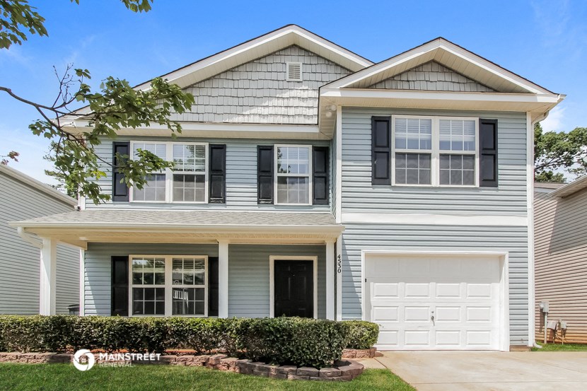 a blue house with a white garage door