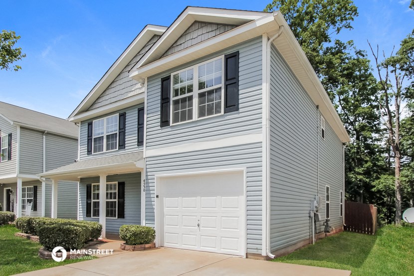 a blue house with a white garage door