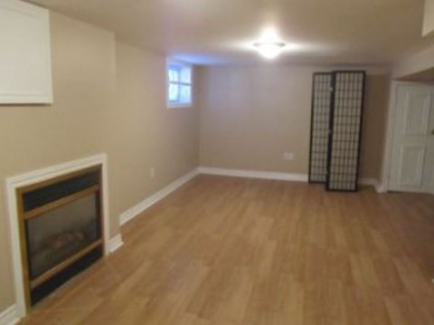 a living room with a fireplace and a wooden floor