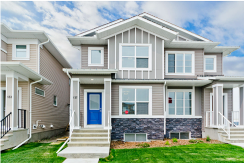 A modern two-story house with a blue front door.