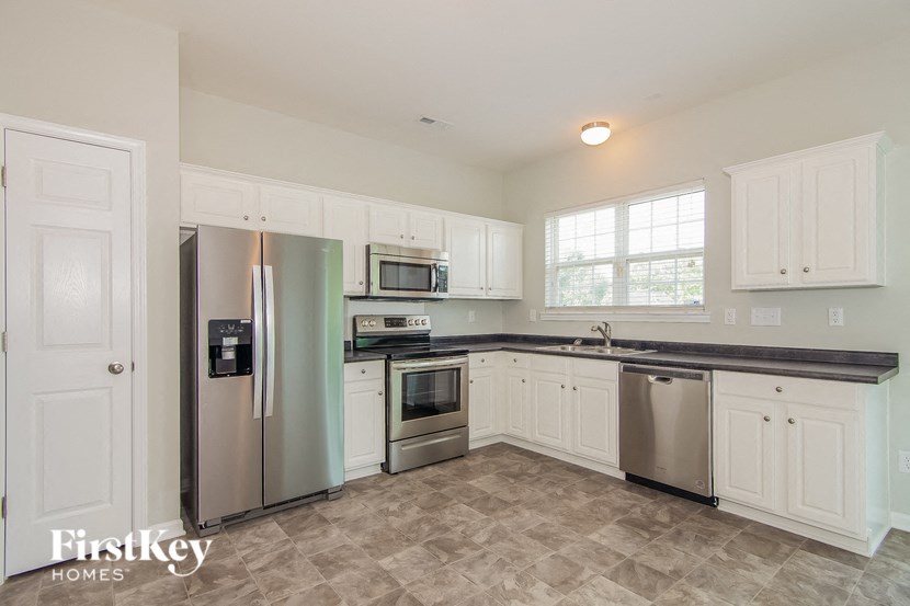 a kitchen with stainless steel appliances and white cabinets