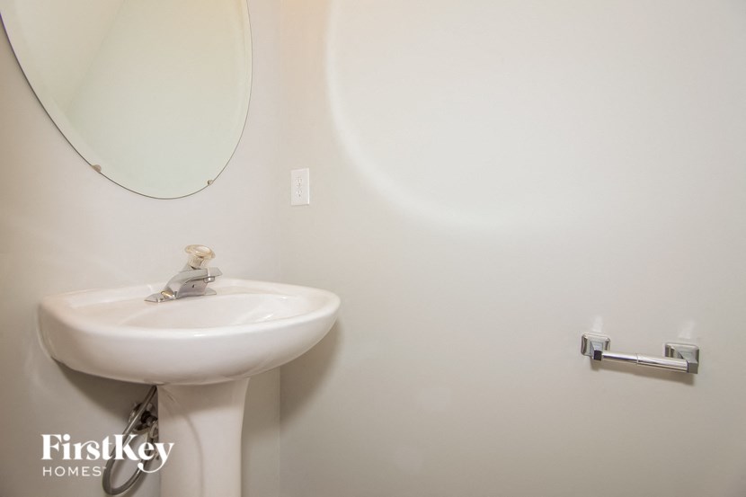 a white bathroom with a sink and a mirror