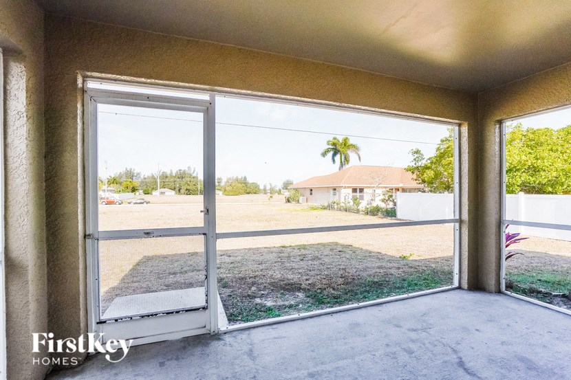 a view of the yard from the living room of a home with a large window