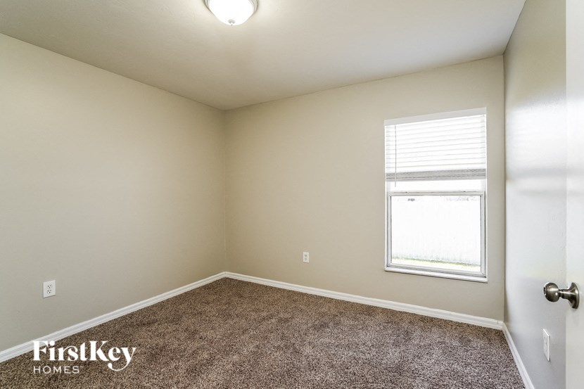 an empty room with carpet and a window