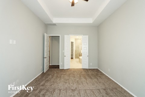 a living room with a carpet and a door to a hallway