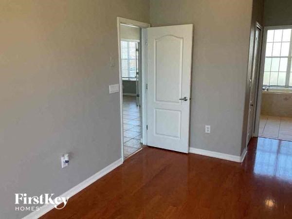 a living room with a wooden floor and a white door