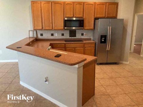 a kitchen with a counter top and a refrigerator