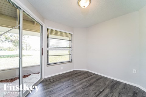 a living room with a sliding glass door and a window