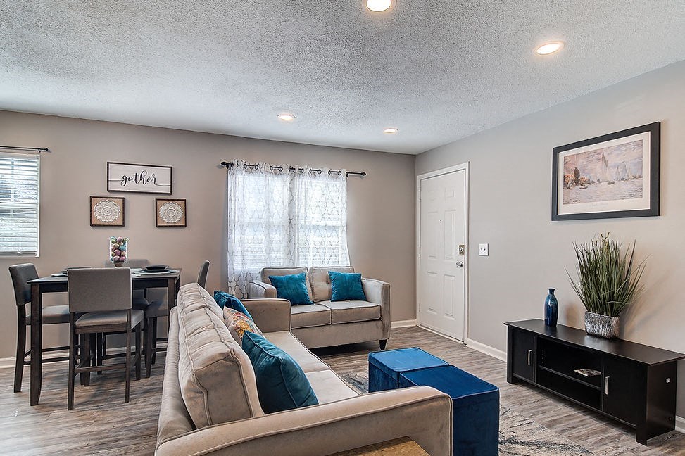 a living room and dining room with a couch and a table