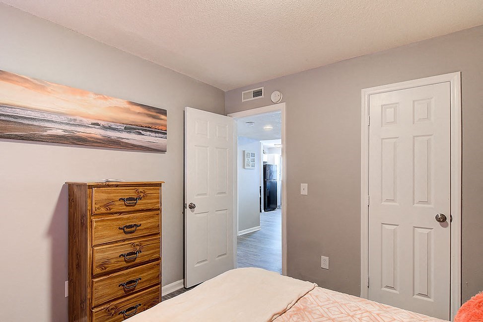 a bedroom with a bed and a dresser