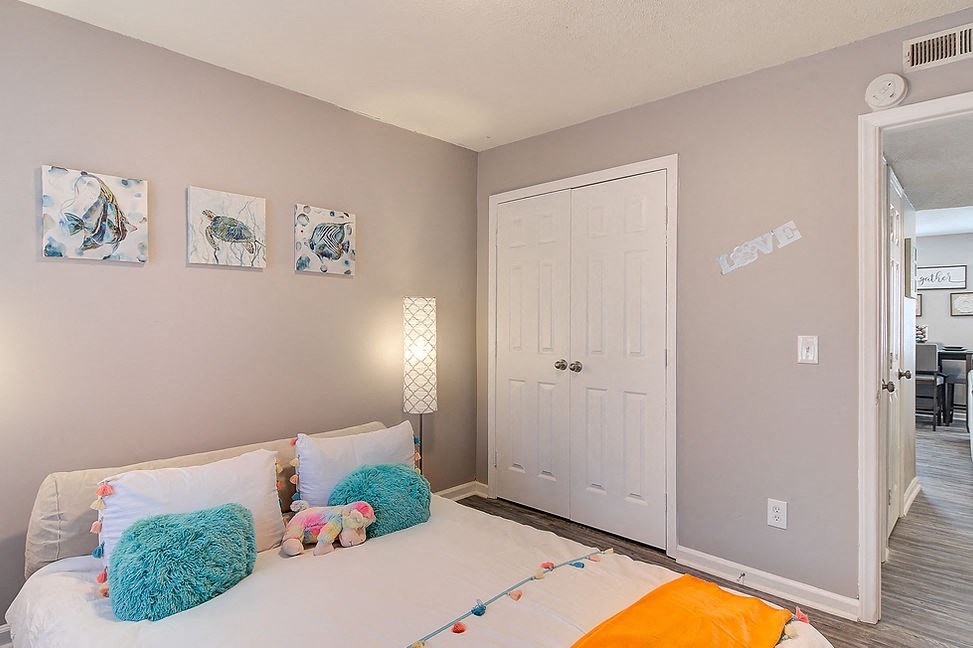 a bedroom with a bed and some pillows on it