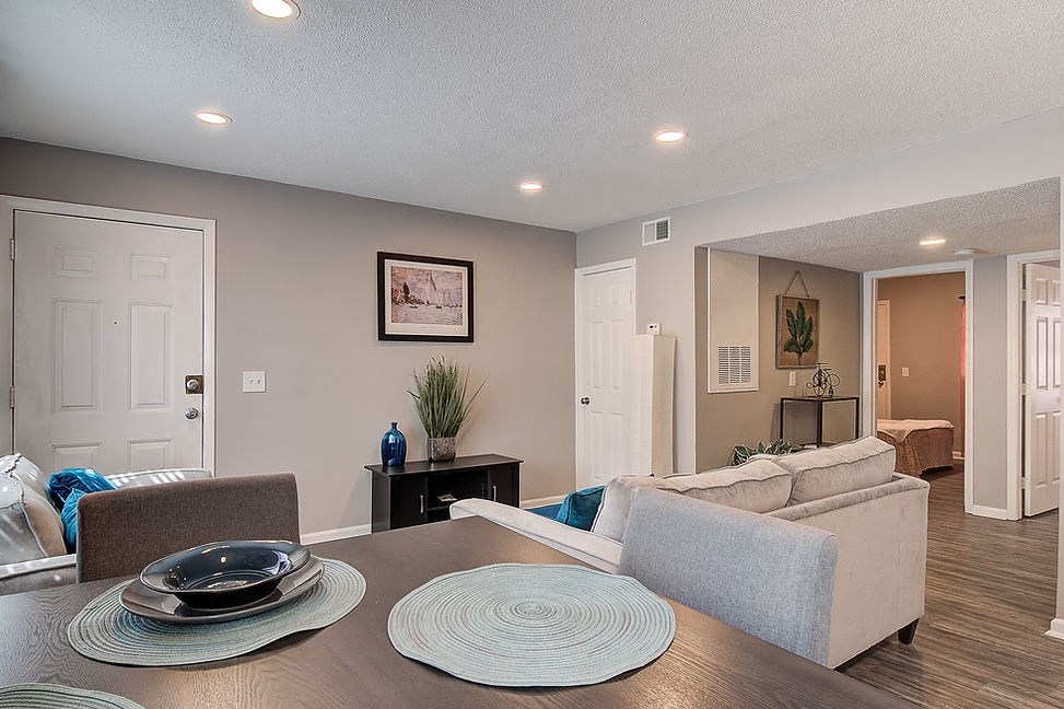 a living room with a table and a couch