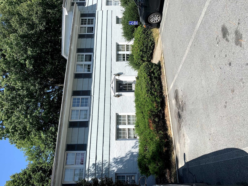 an aerial view of an apartment building with a car parked on the street