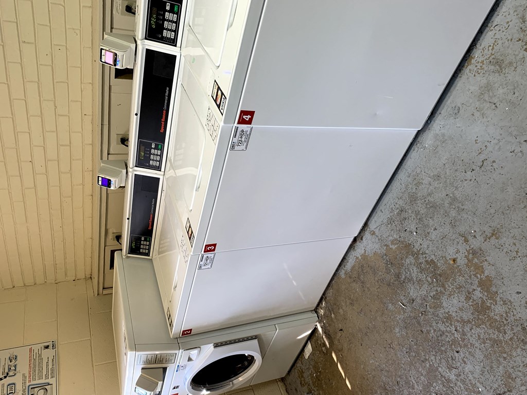 a white refrigerator freezer sitting next to a wall