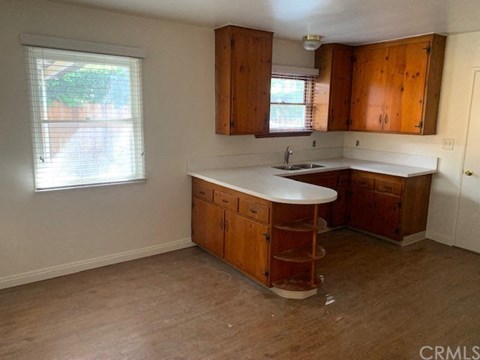 A kitchen with wooden cabinets and a white countertop.