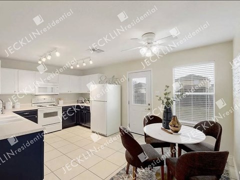 A modern kitchen with a dining table set for four.