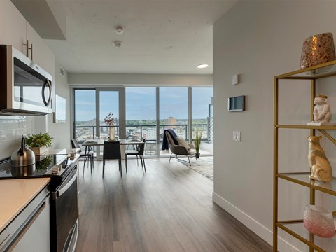 an open kitchen and living room with a view of the city