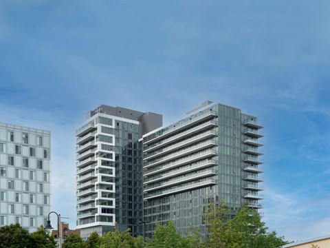 two tall buildings with a blue sky in the background