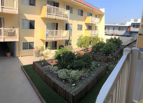 a view of a building with a garden in front of it